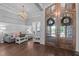 Elegant foyer with hardwood floors, a chandelier, and double doors leading to the living space at 2112 Colin Hill Ct, Wake Forest, NC 27587