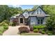 Stunning exterior of home with stone accents, landscaped yard, and driveway leading to the garage at 2112 Colin Hill Ct, Wake Forest, NC 27587