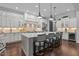 Spacious kitchen features an oversized island, stainless appliances, and stylish pendant lighting at 2112 Colin Hill Ct, Wake Forest, NC 27587