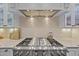 Close-up of a professional grade stainless steel range and custom tile backsplash at 2112 Colin Hill Ct, Wake Forest, NC 27587