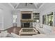 Comfortable living room with stone fireplace, built-in shelving, and bright lighting at 2112 Colin Hill Ct, Wake Forest, NC 27587
