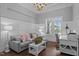 Bright living room with hardwood floors, wainscoting, and a large window at 2112 Colin Hill Ct, Wake Forest, NC 27587