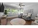 Cozy living room with hardwood floors, comfortable seating and natural light from large windows at 2112 Colin Hill Ct, Wake Forest, NC 27587