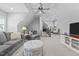 Open floor living room featuring gray sofas and open staircase at 2112 Colin Hill Ct, Wake Forest, NC 27587