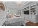 This spacious main bedroom features a chandelier, wood floors, and an entertainment center at 2112 Colin Hill Ct, Wake Forest, NC 27587