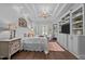 This spacious main bedroom features a chandelier, wood floors, and an entertainment center at 2112 Colin Hill Ct, Wake Forest, NC 27587