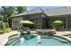Luxurious outdoor pool with a spa and a covered patio seating area, perfect for relaxation and entertainment at 2112 Colin Hill Ct, Wake Forest, NC 27587