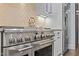 Close-up of a professional grade stainless steel range and custom tile backsplash at 2112 Colin Hill Ct, Wake Forest, NC 27587