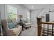 Cozy sitting area features floral chairs, shuttered windows, and neutral tones for a relaxing ambiance at 2112 Colin Hill Ct, Wake Forest, NC 27587