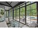 Enclosed sunroom with stone floors overlooks the pool and outdoor dining area at 2112 Colin Hill Ct, Wake Forest, NC 27587