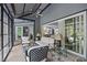 Bright sunroom featuring stone floors, comfortable seating and views into the home at 2112 Colin Hill Ct, Wake Forest, NC 27587