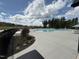 Community pool area with modern lounge chairs and mature trees in the background at 2112 Pink Peony Cir # 149, Durham, NC 27703