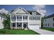 Charming two-story home featuring a double front porch, a two-car garage, and manicured landscaping at 221 Savannah Moss Way # 119, Raleigh, NC 27603
