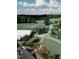 Stunning aerial view of a golf course with lush greenery, a clubhouse, and well-manicured landscaping at 237 Emory Bluffs Dr, Holly Springs, NC 27540
