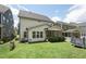 Spacious backyard with green grass, a trampoline, and an outdoor seating area at 237 Emory Bluffs Dr, Holly Springs, NC 27540