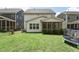 Large backyard with green grass, an outdoor grill, and a trampoline at 237 Emory Bluffs Dr, Holly Springs, NC 27540