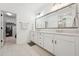 This luxurious bathroom features double sinks, quartz countertops and a walk-in shower at 237 Emory Bluffs Dr, Holly Springs, NC 27540
