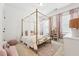 Bright bedroom with a four poster bed frame, soft textures, and plenty of natural light at 237 Emory Bluffs Dr, Holly Springs, NC 27540