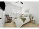 Cozy bedroom with neutral tones, complemented by a rocking chair and bright natural light at 237 Emory Bluffs Dr, Holly Springs, NC 27540