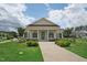 Inviting community clubhouse featuring well-manicured landscaping at 237 Emory Bluffs Dr, Holly Springs, NC 27540