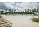 Expansive community pool with lounge chairs and shaded seating areas at 237 Emory Bluffs Dr, Holly Springs, NC 27540