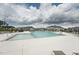 Large community pool surrounded by lounge chairs and neighboring homes at 237 Emory Bluffs Dr, Holly Springs, NC 27540
