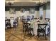 Elegant dining room featuring beautifully set tables, decorative chandeliers, and stylish modern decor at 237 Emory Bluffs Dr, Holly Springs, NC 27540