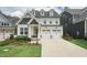 Beautiful two-story home featuring a two-car garage and a well-manicured lawn at 237 Emory Bluffs Dr, Holly Springs, NC 27540