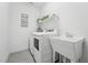 Convenient laundry room with sink, shelving, and modern appliances at 237 Emory Bluffs Dr, Holly Springs, NC 27540