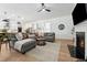 Open-concept living room with hardwood floors, a neutral color palette, and seamless flow to the kitchen at 237 Emory Bluffs Dr, Holly Springs, NC 27540