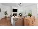 Cozy living room with a fireplace, hardwood floors, a ceiling fan, and plenty of natural light at 237 Emory Bluffs Dr, Holly Springs, NC 27540