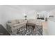 The living room features neutral sofas, decorative rug and lighting at 237 Emory Bluffs Dr, Holly Springs, NC 27540