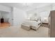 Bright primary suite showcases neutral decor, bedside tables, and large windows at 237 Emory Bluffs Dr, Holly Springs, NC 27540