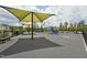 Community playground featuring shaded seating, play structures, and soft flooring at 237 Emory Bluffs Dr, Holly Springs, NC 27540