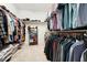 This large walk-in closet is complete with ample shelving and custom clothing racks at 237 Emory Bluffs Dr, Holly Springs, NC 27540