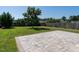 Spacious backyard featuring a patio and lush green grass surrounded by mature trees and a wood fence at 2826 Tulip Poplar Cir, Durham, NC 27704