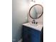 Stylish bathroom vanity with a round mirror and attractive finishes at 2826 Tulip Poplar Cir, Durham, NC 27704