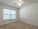Bright, empty bedroom with carpet and large window at 2826 Tulip Poplar Cir, Durham, NC 27704