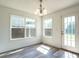 Bright dining area with new laminate floors, white walls, plenty of natural light and modern light fixture at 2826 Tulip Poplar Cir, Durham, NC 27704