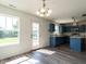 Bright dining area leads to a stunning kitchen, featuring white walls and laminate floors at 2826 Tulip Poplar Cir, Durham, NC 27704
