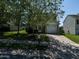 Inviting home featuring a driveway, well-maintained lawn, and mature trees for shade and curb appeal at 2826 Tulip Poplar Cir, Durham, NC 27704