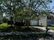 Charming two-story home featuring a well-manicured lawn, mature trees, and an attached two-car garage at 2826 Tulip Poplar Cir, Durham, NC 27704