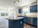 Bright kitchen features an island, stainless steel appliances, and blue cabinets at 2826 Tulip Poplar Cir, Durham, NC 27704