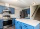 Well-equipped kitchen with stainless steel appliances, white countertops, and light blue cabinets at 2826 Tulip Poplar Cir, Durham, NC 27704