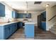 Modern kitchen with stylish blue cabinets, stainless steel appliances, and a convenient island at 2826 Tulip Poplar Cir, Durham, NC 27704