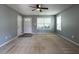Spacious living room featuring carpet, gray walls, ample natural light, and a modern ceiling fan at 2826 Tulip Poplar Cir, Durham, NC 27704
