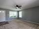Inviting living room with carpet, gray walls, plenty of natural light and a contemporary ceiling fan at 2826 Tulip Poplar Cir, Durham, NC 27704