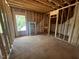 Unfinished attic space featuring exposed wood beams, rafters, subflooring and window at 30 Cherry Bark Dr, Youngsville, NC 27596