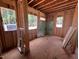 An unfinished bedroom with exposed framing, windows, and plywood flooring at 30 Cherry Bark Dr, Youngsville, NC 27596