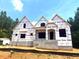 New home under construction with guard wrap and window openings, set on a beautiful wooded lot at 30 Cherry Bark Dr, Youngsville, NC 27596